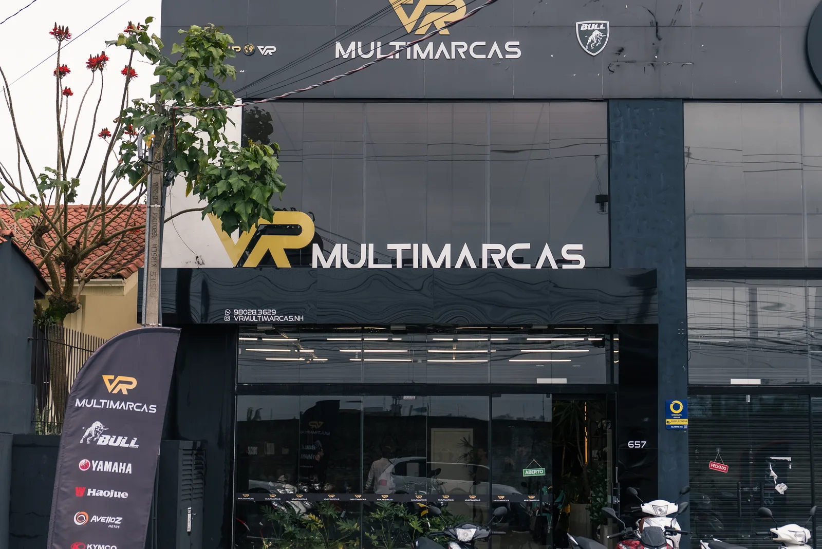Fachada de uma loja da rede VR Multimarcas, com motos expostas na vitrine